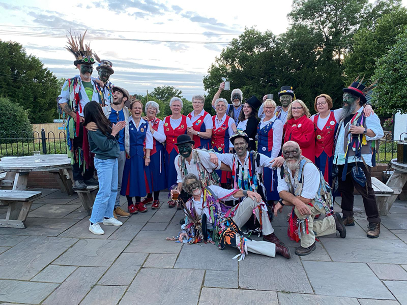 the Butterflies posing with Alvechurch Morris men and visitors during their dance out at the Coach and Horses Weatheroak